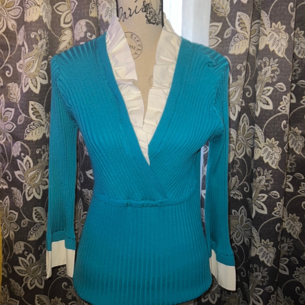 Long-sleeved business casual or dressy sweater with white trimmings.